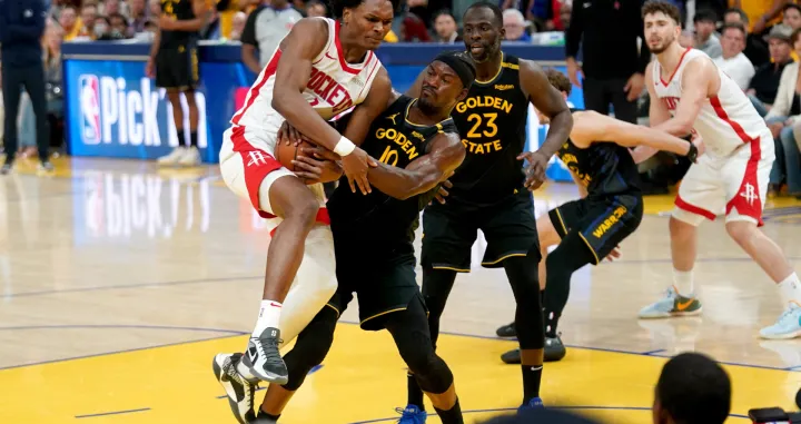 May 2, 2025; San Francisco, California, USA; Golden State Warriors forward Jimmy Butler III (10) forces a jump ball while defending Houston Rockets forward Amen Thompson (1) in the fourth quarter of game six of the first round for the 2025 NBA Playoffs at Chase Center. Mandatory Credit: Cary Edmondson-Imagn Images
