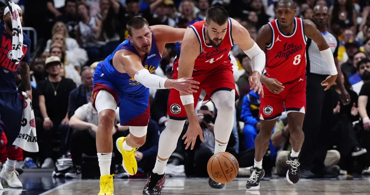 May 3, 2025; Denver, Colorado, USA; LA Clippers center Ivica Zubac (40) steals the ball away from Denver Nuggets center Nikola Jokic (15) in the second quarter during game seven of first round for the 2025 NBA Playoffs at Ball Arena. Mandatory Credit: Ron Chenoy-Imagn Images