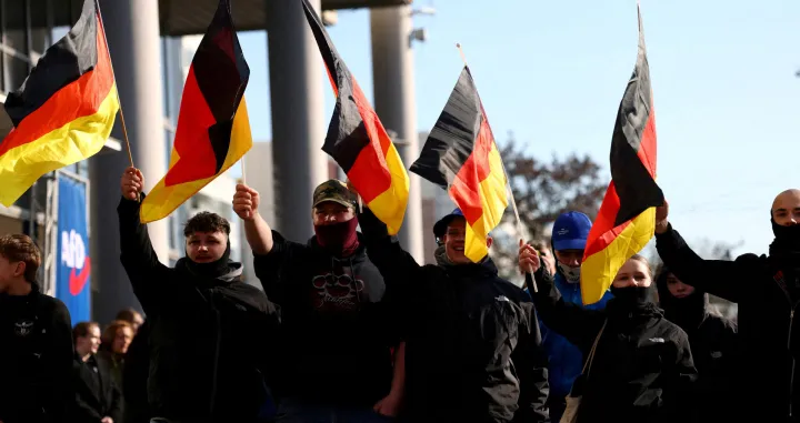FILE PHOTO: Supporters of the Alternative for Germany party (AfD) wave flags as they take part in an AfD campaign rally in Hohenschoenhausen, Berlin, Germany, February 22, 2025. REUTERS/Christian Mang/File Photo/Christian Mang