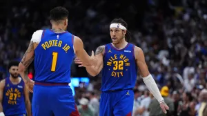 May 9, 2025; Denver, Colorado, USA; Denver Nuggets forward Aaron Gordon (32) celebrates his three point score with forward Michael Porter Jr. (1) in the fourth quarter against the Oklahoma City Thunder during game three of the second round for the 2025 NBA Playoffs at Ball Arena. Mandatory Credit: Ron Chenoy-Imagn Images