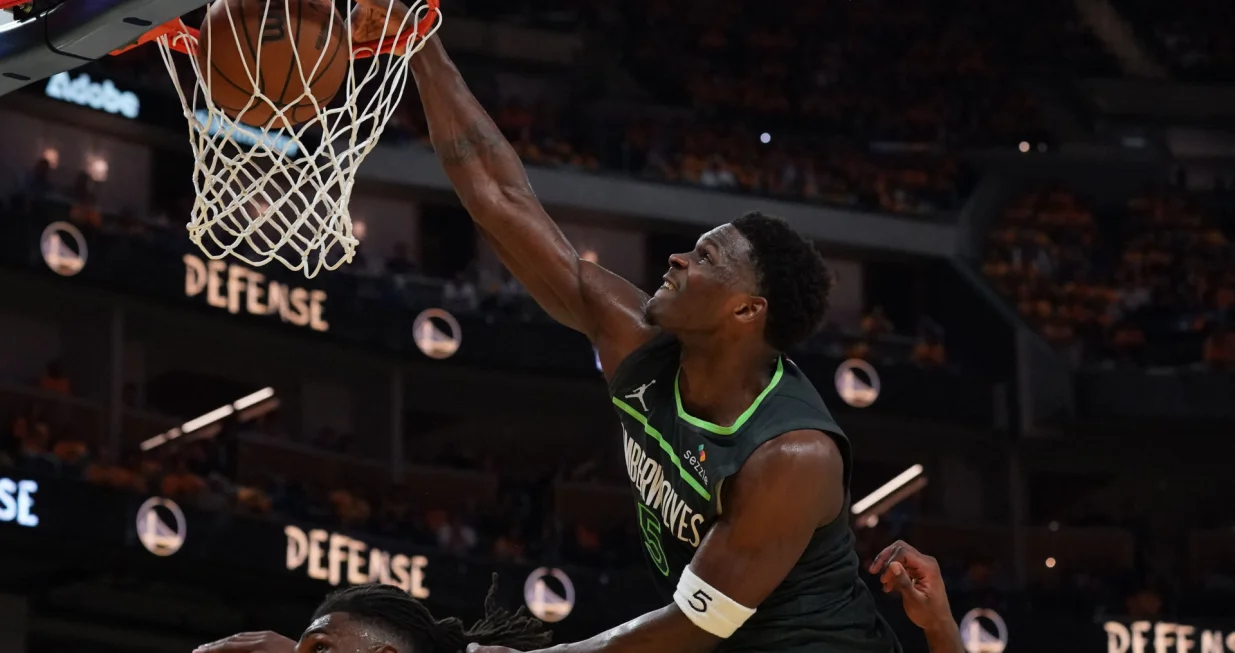 May 10, 2025; San Francisco, California, USA; Minnesota Timberwolves guard Anthony Edwards (5) dunks over Golden State Warriors forward Kevon Looney (5) in the third quarter during game three in the second round for the 2025 NBA Playoffs at Chase Center. Mandatory Credit: David Gonzales-Imagn Images