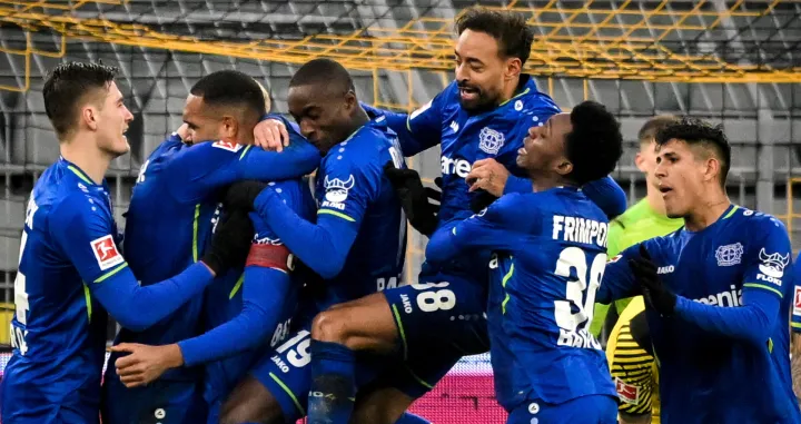 epa09733178 Leverkusen's Jonathan Tah (3-L) celebrates with teammates after scoring the 4-1 lead during the German Bundesliga soccer match between Borussia Dortmund and Bayer Leverkusen in Dortmund, Germany, 06 February 2022. EPA/SASCHA STEINBACH CONDITIONS - ATTENTION: The DFL regulations prohibit any use of photographs as image sequences and/or quasi-video.