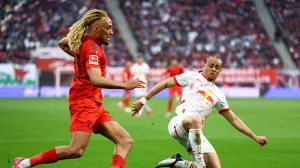 Soccer Football - Bundesliga - RB Leipzig v Bayern Munich - Red Bull Arena, Leipzig, Germany - May 3, 2025 Bayern Munich's Sacha Boey in action with RB Leipzig's Xavi Simons REUTERS/Lisi Niesner DFL REGULATIONS PROHIBIT ANY USE OF PHOTOGRAPHS AS IMAGE SEQUENCES AND/OR QUASI-VIDEO.