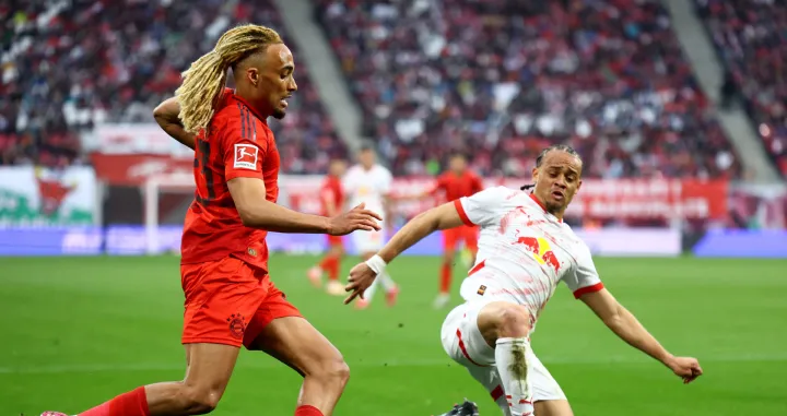 Soccer Football - Bundesliga - RB Leipzig v Bayern Munich - Red Bull Arena, Leipzig, Germany - May 3, 2025 Bayern Munich's Sacha Boey in action with RB Leipzig's Xavi Simons REUTERS/Lisi Niesner DFL REGULATIONS PROHIBIT ANY USE OF PHOTOGRAPHS AS IMAGE SEQUENCES AND/OR QUASI-VIDEO.