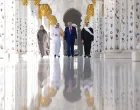 U.S. President Donald Trump is reflected off the floor as he walks with Yousif Al Obaidli, director of Sheikh Zayed Grand Mosque and Ameena Al Hammadi, acting director of the Culture and Knowledge Department while visiting the Sheikh Zayed Grand Mosque in Abu Dhabi, United Arab Emirates, May 15, 2025. REUTERS/Brian Snyder/Brian Snyder
