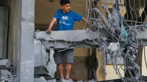 A Palestinian man looks from the damaged house in the aftermath of an Israeli strike, in Jabalia, northern Gaza Strip May 18, 2025. REUTERS/Mahmoud Issa/Mahmoud Issa
