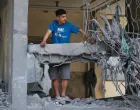 A Palestinian man looks from the damaged house in the aftermath of an Israeli strike, in Jabalia, northern Gaza Strip May 18, 2025. REUTERS/Mahmoud Issa/Mahmoud Issa