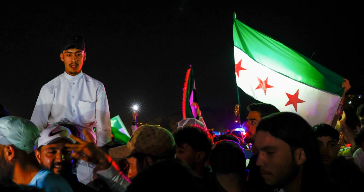 People celebrate after U.S. President Donald Trump said on Tuesday he would order the lifting of sanctions on Syria, in Damascus, Syria May 13, 2025. REUTERS/Yamam Al Shaar/Yamam Al Shaar