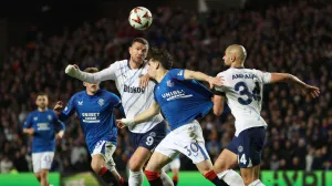Soccer Football - Europa League - Round of 16 - Second Leg - Rangers v Fenerbahce - Ibrox, Glasgow, Scotland, Britain - March 13, 2025 Fenerbahce's Edin Dzeko in action with Rangers' Ianis Hagi REUTERS/Russell Cheyne