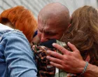 A Ukrainian prisoner of war (POW) reacts as he embraces his relatives after a swap, amid Russia's attack on Ukraine, in an undisclosed location in Ukraine, May 25, 2025. REUTERS/Valentyn Ogirenko/Valentyn Ogirenko