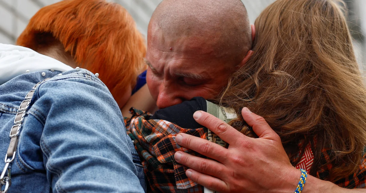 A Ukrainian prisoner of war (POW) reacts as he embraces his relatives after a swap, amid Russia's attack on Ukraine, in an undisclosed location in Ukraine, May 25, 2025. REUTERS/Valentyn Ogirenko/Valentyn Ogirenko