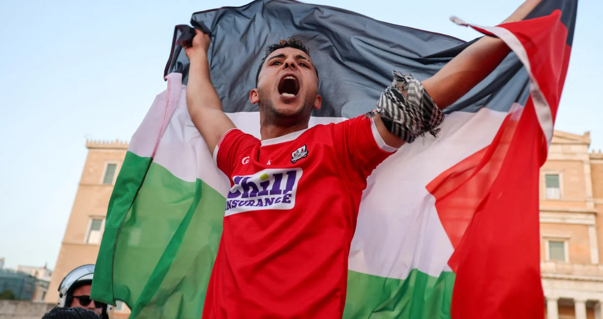 A protester holding a Palestinian flag chants slogans in front of the Greek parliament, during a rally in support to Palestinian people, amid the ongoing conflict between Israel and Hamas, in Athens, Greece, May 21, 2025. REUTERS/Louisa Gouliamaki/Louisa Gouliamaki
