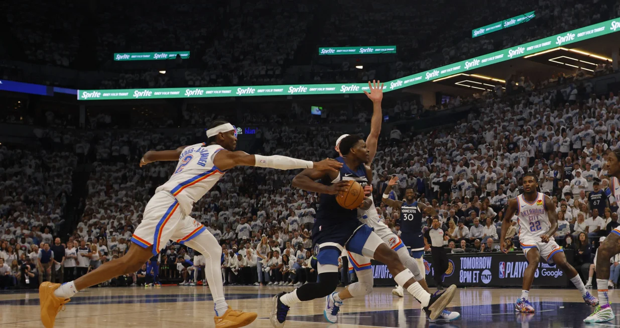 May 26, 2025; Minneapolis, Minnesota, USA; Minnesota Timberwolves guard Anthony Edwards (5) dribbles the ball past Oklahoma City Thunder guard Shai Gilgeous-Alexander (2) in the second half during game four of the western conference finals for the 2025 NBA Playoffs at Target Center. Mandatory Credit: Bruce Kluckhohn-Imagn Images