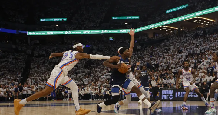 May 26, 2025; Minneapolis, Minnesota, USA; Minnesota Timberwolves guard Anthony Edwards (5) dribbles the ball past Oklahoma City Thunder guard Shai Gilgeous-Alexander (2) in the second half during game four of the western conference finals for the 2025 NBA Playoffs at Target Center. Mandatory Credit: Bruce Kluckhohn-Imagn Images