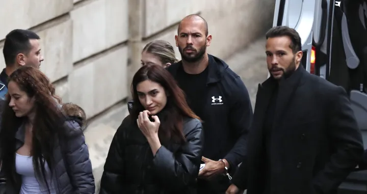 epa10397729 Former professional kickboxer and social media influencer, American-British businessman Andrew Tate (C), his brother Tristan (R), and unidentified women are escorted by Romanian police officers inside the Court of Appeal building for a hearing in their trial in Bucharest, Romania, 10 January 2023. On 29 December 2022, Andrew and Tristan Tate were arrested as a result of Directorate for Investigating Organized Crime and Terrorism (DIICOT) division inquiry under the charges of human trafficking and the intention of forming an organized crime group. Romanian police stated that the two brothers and their associates coerced victims for creating a paid pornography service for social media platforms. A Romanian judge ordered on 30 December 2022 that Andrew Tate shall remain in police custody for 30 days, as criminal police investigation is ongoing. In total, 11 cars and ten buildings located near Bucharest, or in Ilfov and Prahova counties, owned by the Tate brothers, were seized by the Romanian authorities until the inquiry will be finished. EPA/Robert Ghement/Robert Ghement