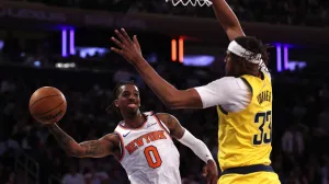May 29, 2025; New York, New York, USA; New York Knicks guard Delon Wright (0) controls the ball against Indiana Pacers center Myles Turner (33) in the fourth quarter during game five of the eastern conference finals for the 2025 NBA Playoffs at Madison Square Garden. Mandatory Credit: Vincent Carchietta-Imagn Images