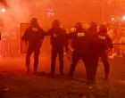 Soccer Football - Champions League - Final - Paris St Germain fans gather in Paris - Paris, France - May 31, 2025 Riot police protect themselves from fans on the Champs Elysees avenue after Paris St Germain won the Champions League REUTERS/Abdul Saboor
