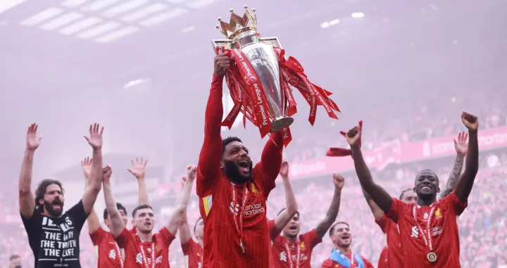 Soccer Football - Premier League - Liverpool v Crystal Palace - Anfield, Liverpool, Britain - May 25, 2025 Liverpool's Joe Gomez celebrates with the trophy after winning the Premier League REUTERS/Phil Noble EDITORIAL USE ONLY. NO USE WITH UNAUTHORIZED AUDIO, VIDEO, DATA, FIXTURE LISTS, CLUB/LEAGUE LOGOS OR 'LIVE' SERVICES. ONLINE IN-MATCH USE LIMITED TO 120 IMAGES, NO VIDEO EMULATION. NO USE IN BETTING, GAMES OR SINGLE CLUB/LEAGUE/PLAYER PUBLICATIONS. PLEASE CONTACT YOUR ACCOUNT REPRESENTATIVE FOR FURTHER DETAILS..