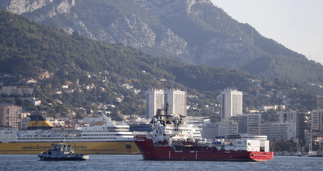 epa10299296 The Ocean Viking rescue ship (R), operated by French maritime-humanitarian organization SOS Mediterranee, enters the harbor escorted by a military boat (L), in Toulon, France, 11 November 2022. SOS Mediterranee on 10 November announced receiving the green light by French authorities to allow the over 230 migrants onboard to disembark in Toulon. The vessel spent weeks at sea after rescuing migrants during several operations throughout October. EPA/GUILLAUME HORCAJUELO/Guillaume Horcajuelo