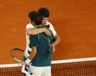 Tennis - French Open - Roland Garros, Paris, France - June 6, 2025 Italy's Lorenzo Musetti hugs Spain's Carlos Alcaraz as he walks off the court after retiring from the semi final match REUTERS/Lisi Niesner