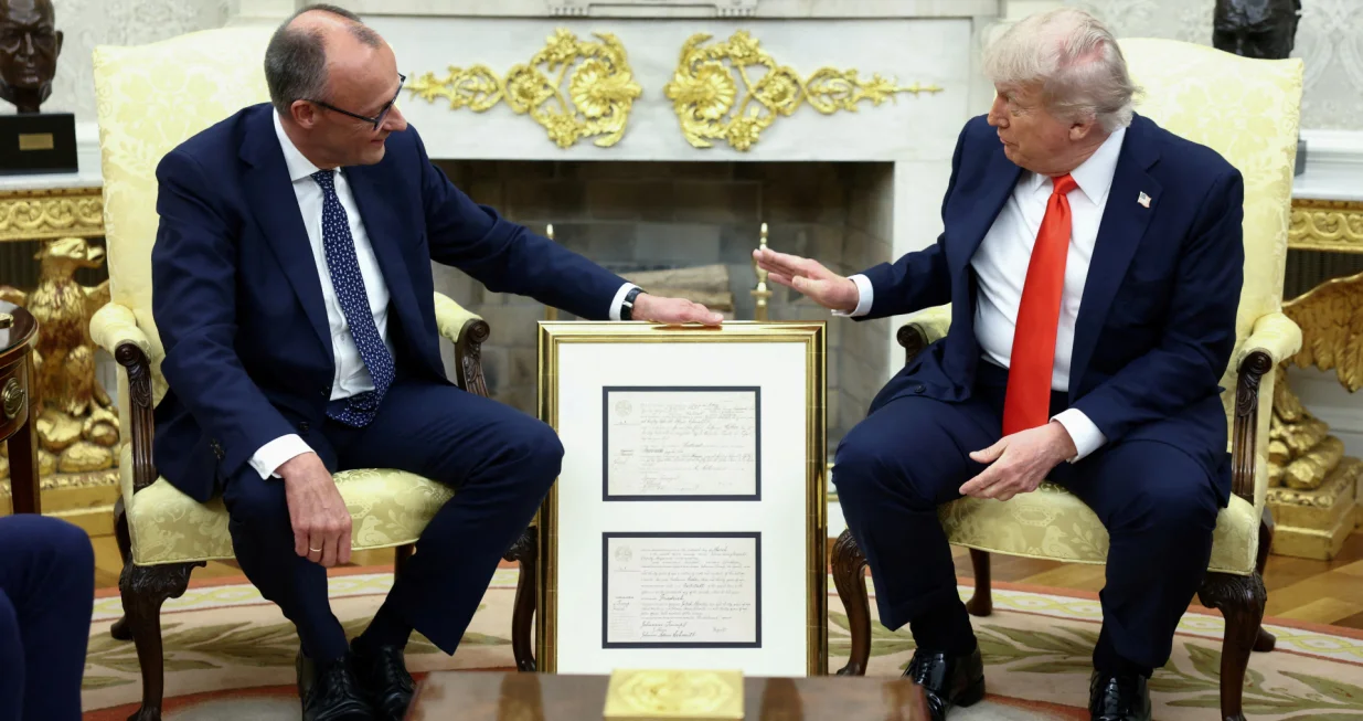 German Chancellor Friedrich Merz holds the birth certificate of U.S. President Donald Trump's grandfather during a meeting at the White House in Washington, D.C., U.S., June 5, 2025. REUTERS/Kevin Lamarque  TPX IMAGES OF THE DAY/Kevin Lamarque