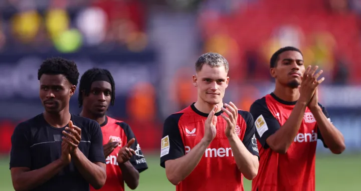 Soccer Football - Bundesliga - Bayer Leverkusen v Borussia Dortmund - BayArena, Leverkusen, Germany - May 11, 2025 Bayer Leverkusen's Florian Wirtz and Jeremie Frimpong applaud fans with teammates after the match REUTERS/Thilo Schmuelgen DFL REGULATIONS PROHIBIT ANY USE OF PHOTOGRAPHS AS IMAGE SEQUENCES AND/OR QUASI-VIDEO.
