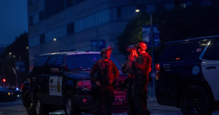 Law enforcement officers including LA County Sheriffs stand as they block off Alameda Street in front of Metropolitan Detention Center, after the California National Guard was deployed by U.S. President Donald Trump as a response to protests against federal immigration sweeps, in downtown Los Angeles, California, U.S., June 9, 2025. REUTERS/Jill Connelly/Jill Connelly