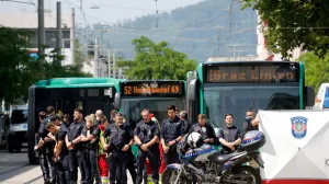 Police officers stand as children are evacuated from the school, following a deadly school shooting in Graz, Austria, June 10, 2025. REUTERS/Borut Zivulovic  TPX IMAGES OF THE DAY/Borut Zivulovic