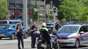 Police officers stand guard near a school following a deadly school shooting in Graz, Austria, June 10, 2025. REUTERS/Leonhard Foeger/Leonhard Foeger