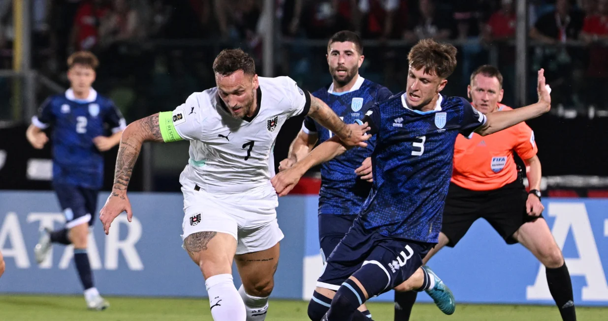 Soccer Football - World Cup - European Qualifiers - Group H - San Marino v Austria - San Marino Stadium, Serravalle, San Marino - June 10, 2025 Austria's Marko Arnautovic in action with San Marino's Tommaso Benvenuti REUTERS/Jennifer Lorenzini
