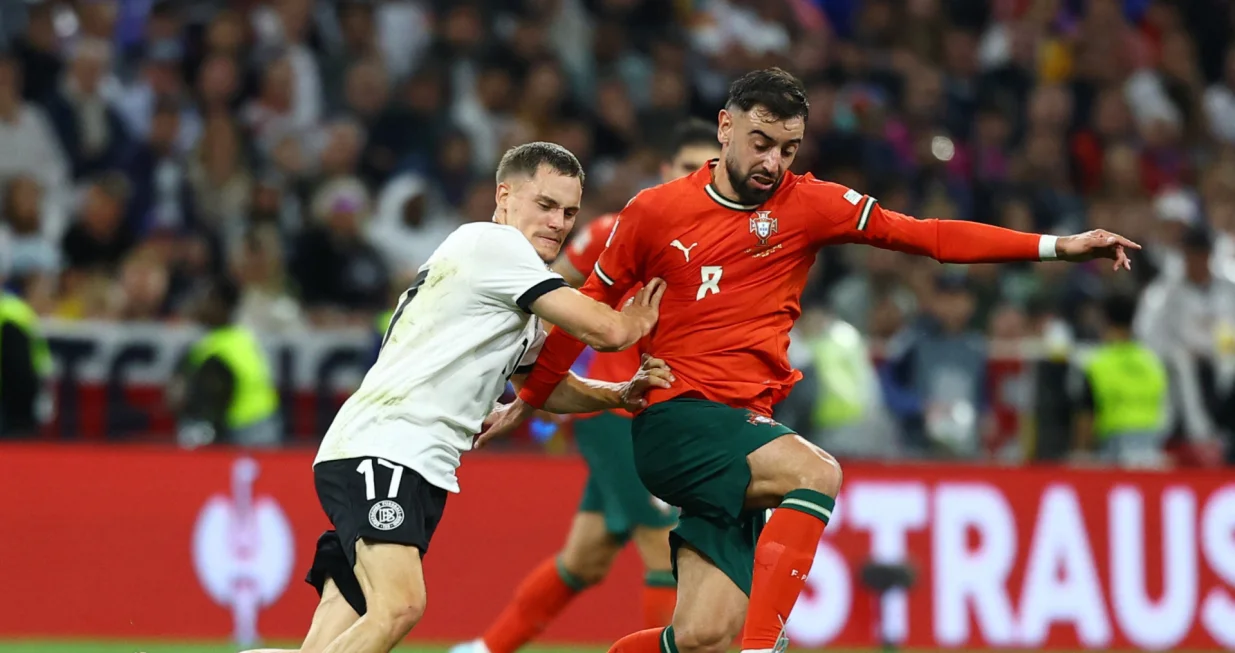 Soccer Football - Nations League - Semi Final - Germany v Portugal - Allianz Arena, Munich, Germany - June 4, 2025 Germany's Florian Wirtz in action with Portugal's Bruno Fernandes REUTERS/Kai Pfaffenbach