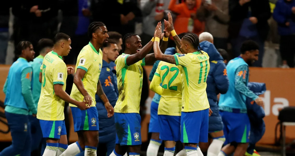 Soccer Football - World Cup - South American Qualifiers - Brazil v Paraguay - Neo Quimica Arena, Sao Paulo, Brazil - June 10, 2025 Brazil's Vinicius Junior celebrates scoring their first goal with Raphinha REUTERS/Jean Carniel