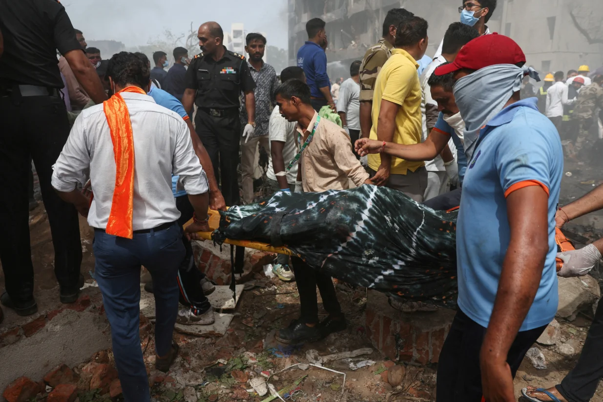 People carry the body of a victim from the crash site after an Air India Boeing 787 Dreamliner plane crashed in Ahmedabad, India, June 12, 2025. REUTERS/Amit Dave TPX IMAGES OF THE DAY/Amit Dave