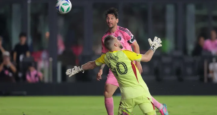 May 28, 2025; Fort Lauderdale, Florida, USA; Inter Miami CF forward Lionel Messi (10) chips the ball over CF Montreal goalkeeper Jonathan Sirois (40) and scores during the second half at Chase Stadium. Mandatory Credit: Sam Navarro-Imagn Images