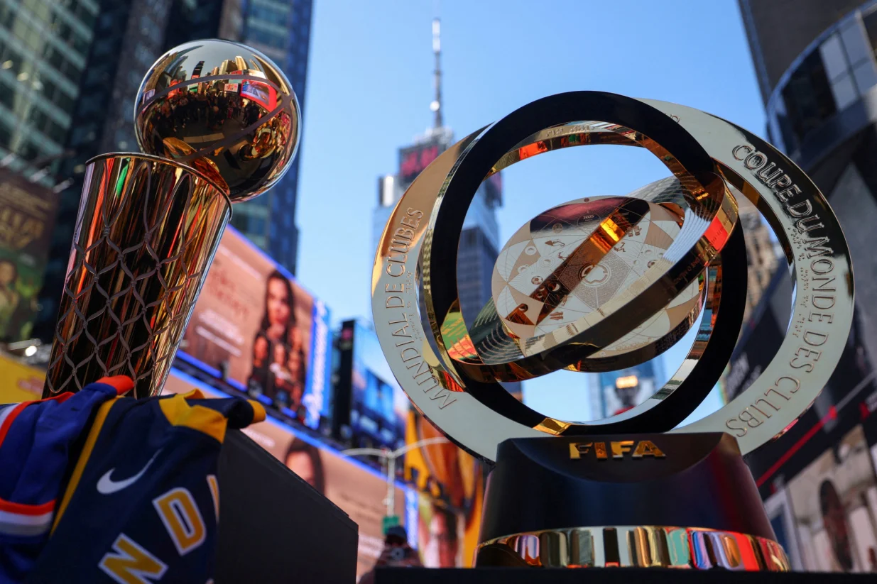 The 2025 NBA Champion Larry O'Brien Trophy and The FIFA Club World Cup 2025 winners trophy are displayed in Times Square ahead of the FIFA tournament featuring 32 teams and 63 matches, spread across 12 stadiums in 11 U.S. cities in June and July, in New York City, U.S., May 20, 2025. REUTERS/Mike Segar  TPX IMAGES OF THE DAY