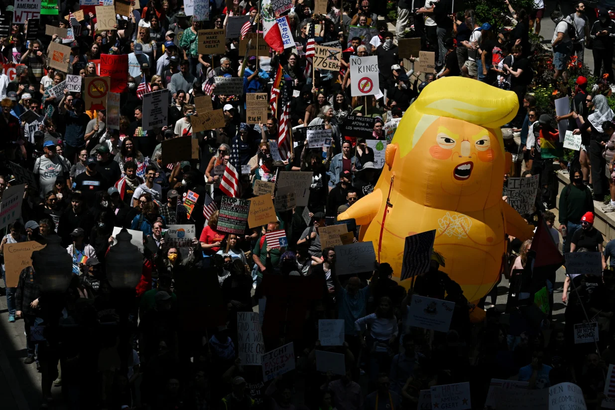 A balloon depicting U.S. President Donald Trump floats, as people take part in the No Kings Day protest against U.S. President Donald Trump's policies, in Chicago, Illinois, U.S., June 14, 2025. REUTERS/Dylan Martinez/Dylan Martinez