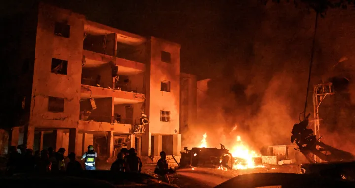 Firefighters and rescue personnel work at an impact site following missile attack from Iran on Israel, in Haifa, Israel, June 15, 2025. REUTERS/Rami Shlush ISRAEL OUT. NO COMMERCIAL OR EDITORIAL SALES IN ISRAEL/Rami Shlush