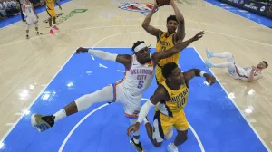 Jun 16, 2025; Oklahoma City, Oklahoma, USA; Indiana Pacers center Tony Bradley (13) rebounds over Oklahoma City Thunder guard Luguentz Dort (5) and Indiana Pacers guard Bennedict Mathurin (00) during the first half during game five of the 2025 NBA Finals at Paycom Center. Mandatory Credit: Nate Billings/Pool Photo via Imagn Images