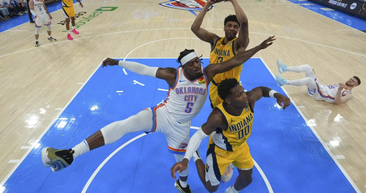 Jun 16, 2025; Oklahoma City, Oklahoma, USA; Indiana Pacers center Tony Bradley (13) rebounds over Oklahoma City Thunder guard Luguentz Dort (5) and Indiana Pacers guard Bennedict Mathurin (00) during the first half during game five of the 2025 NBA Finals at Paycom Center. Mandatory Credit: Nate Billings/Pool Photo via Imagn Images
