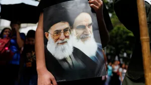 A Venezuelan government supporter holds a sign with an image of Iran's Supreme Leader Ayatollah Ali Khamenei and Iran's late leader Ayatollah Ruhollah Khomeini, while participating in a march in support of Iran amid the ongoing conflict between Israel and Iran, in Caracas, Venezuela June 19, 2025. REUTERS/Leonardo Fernandez Viloria/Leonardo Fernandez Viloria