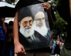 A Venezuelan government supporter holds a sign with an image of Iran's Supreme Leader Ayatollah Ali Khamenei and Iran's late leader Ayatollah Ruhollah Khomeini, while participating in a march in support of Iran amid the ongoing conflict between Israel and Iran, in Caracas, Venezuela June 19, 2025. REUTERS/Leonardo Fernandez Viloria/Leonardo Fernandez Viloria