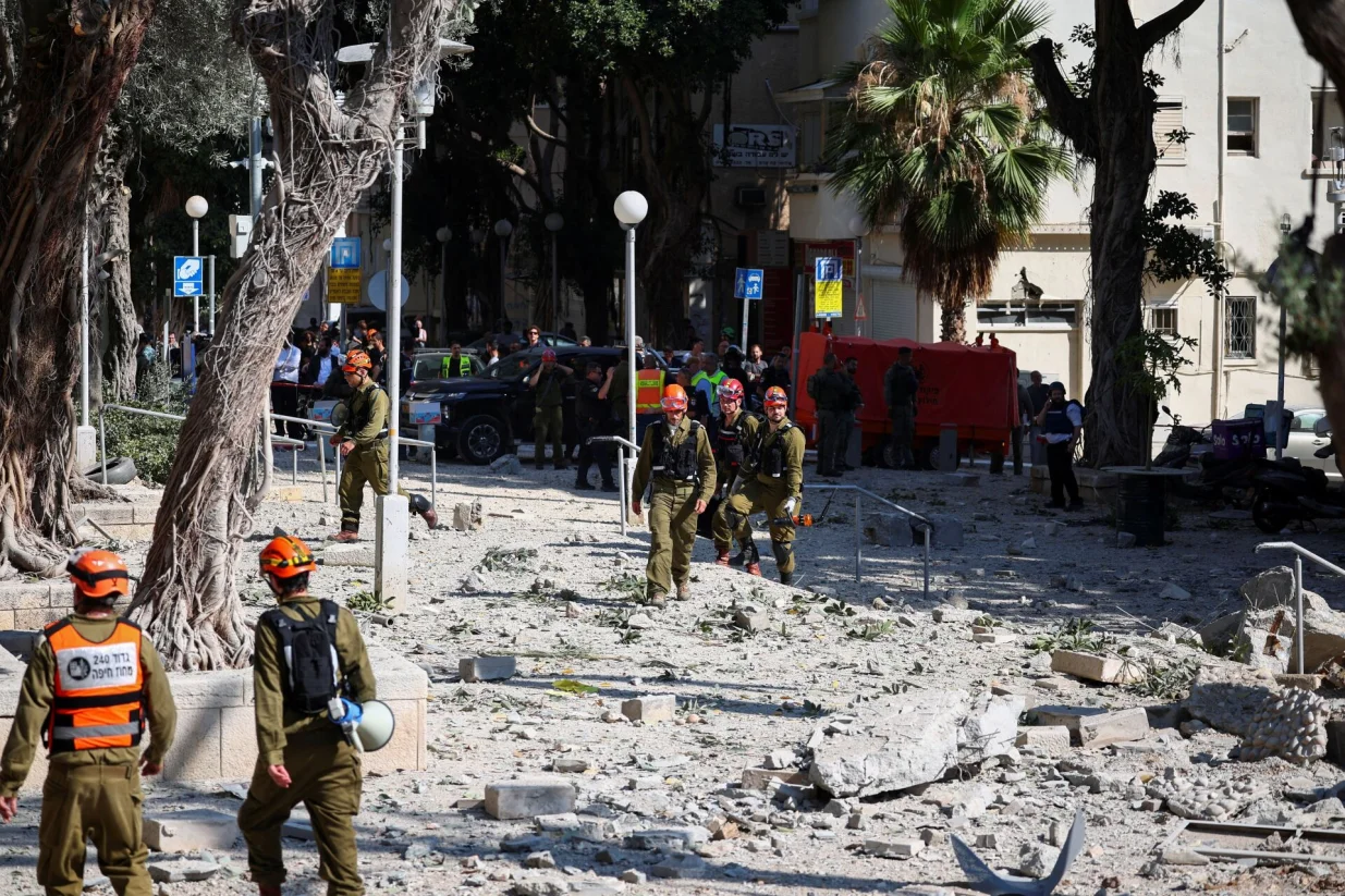 First responders gather at an impact site following Iran's strike on Israel, amid the Iran-Israel conflict, in Haifa, Israel, June 22, 2025. REUTERS/Florion Goga/Florion Goga