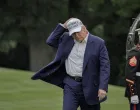 U.S. President Donald Trump holds his hat as he walks on the South Lawn of the White House in Washington, D.C., U.S., May 25, 2025. /Ken Cedeno/Ken Cedeno