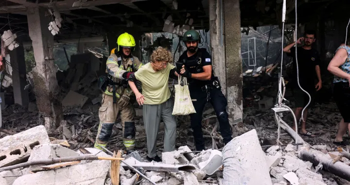First responders gather at an impact site following Iran's strike on Israel, amid the Iran-Israel conflict, in Haifa, Israel, June 22, 2025. REUTERS/Florion Goga/Florion Goga