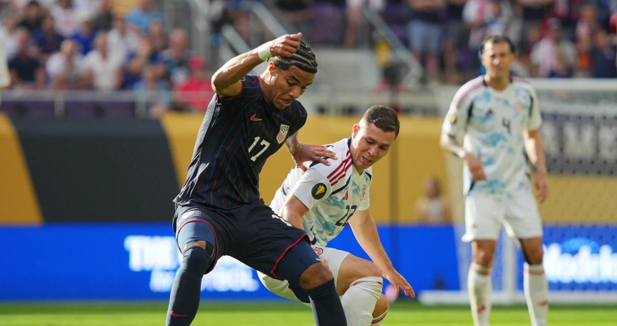 Jun 29, 2025; Minneapolis, Minnesota, USA; United States of America forward Malik Tillman (17) and Costa Rica midfielder Carlos Mora (22) battle for the ball in the first half during a quarterfinal match of the 2025 Gold Cup at U.S. Bank Stadium. Mandatory Credit: Brad Rempel-Imagn Images