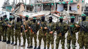FILE PHOTO: Palestinian Hamas militants stand guard on the day of the handover of hostages held in Gaza since the deadly October 7 2023 attack, as part of a ceasefire and a hostages-prisoners swap deal between Hamas and Israel, in Rafah in the southern Gaza Strip, February 22, 2025. REUTERS/Hatem Khaled/File Photo/Hatem Khaled