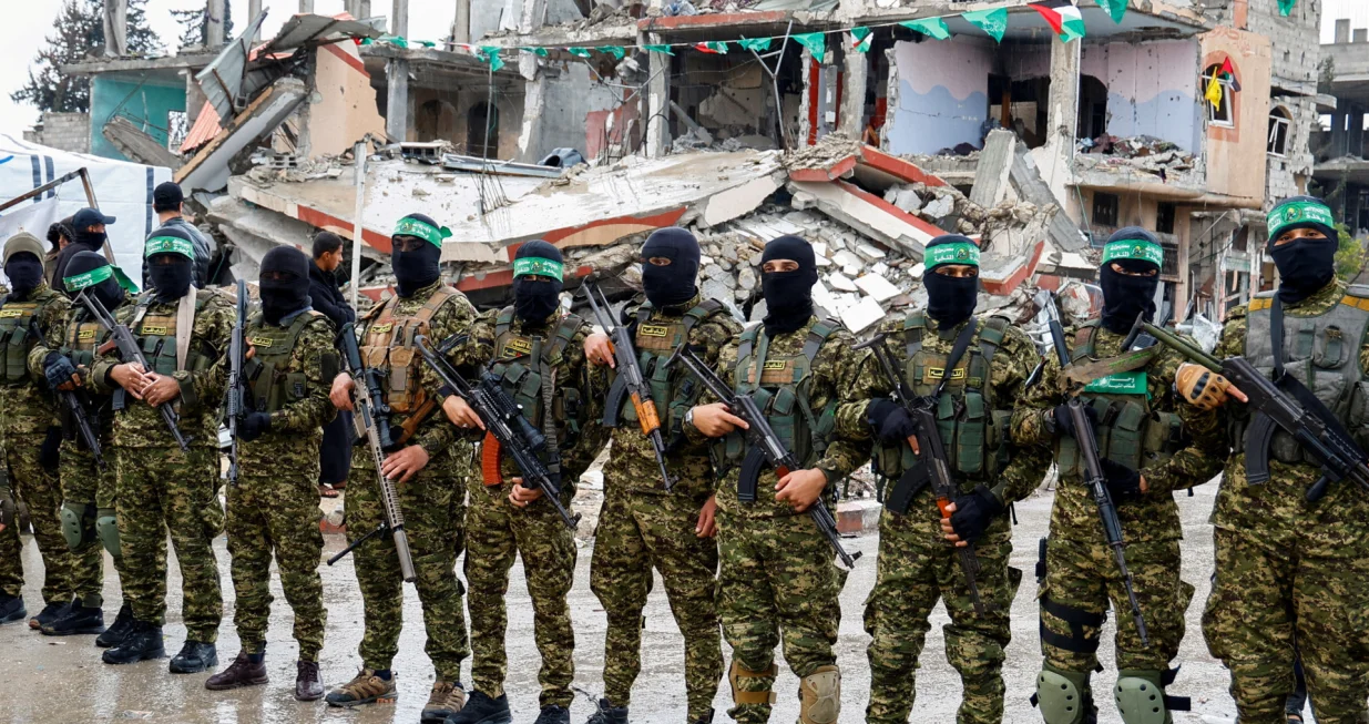 FILE PHOTO: Palestinian Hamas militants stand guard on the day of the handover of hostages held in Gaza since the deadly October 7 2023 attack, as part of a ceasefire and a hostages-prisoners swap deal between Hamas and Israel, in Rafah in the southern Gaza Strip, February 22, 2025. REUTERS/Hatem Khaled/File Photo/Hatem Khaled