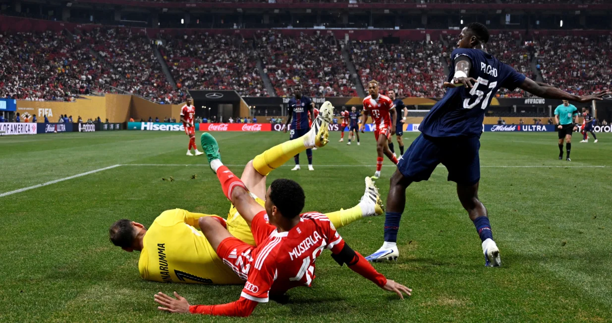 Soccer Football - FIFA Club World Cup - Quarter Final - Paris St Germain v Bayern Munich - Mercedes-Benz Stadium, Atlanta, Georgia, U.S. - July 5, 2025 Bayern Munich's Jamal Musiala sustains an injury after a collision with Paris St Germain's Gianluigi Donnarumma REUTERS/Pablo Morano
