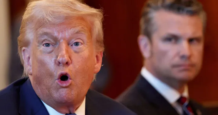 FILE PHOTO: U.S. Defense Secretary Pete Hegseth looks at U.S. President Donald Trump as he speaks during a bilateral dinner with Israeli Prime Minister Benjamin Netanyahu (not pictured), at the White House in Washington, D.C., U.S., July 7, 2025. REUTERS/Kevin Lamarque/File Photo/Reuters/kevin Lamarque/file Photo