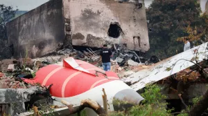 A fire officer stands next to the crashed Air India Boeing 787-8 Dreamliner aircraft, in Ahmedabad, India, June 13, 2025. REUTERS/Adnan Abidi  TPX IMAGES OF THE DAY/Adnan Abidi